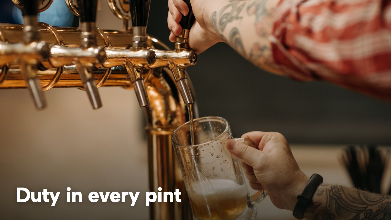 A bartender pouring a pint of lager from a brass tap. The image carries the words "Duty in every pint".