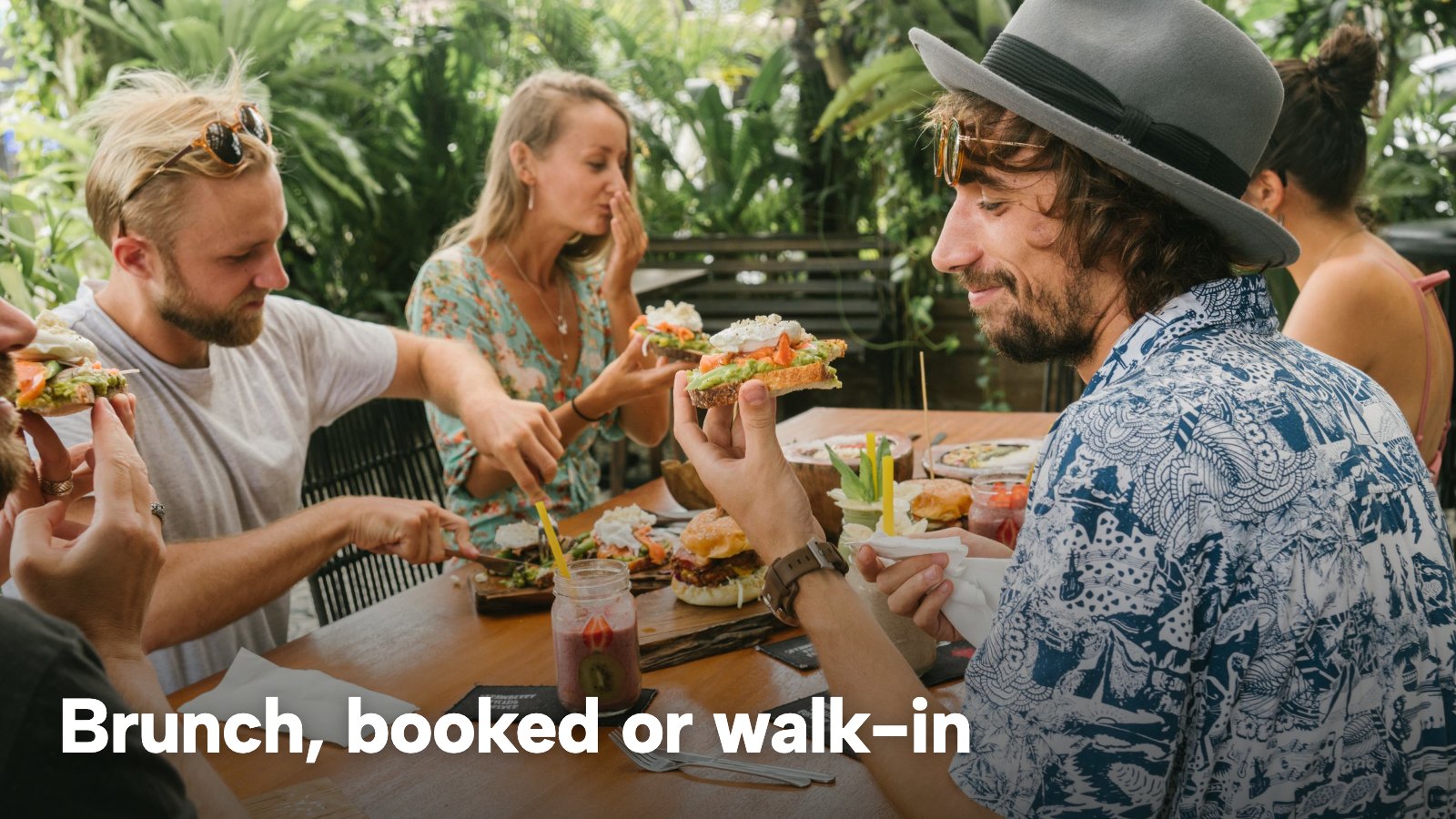 Friends share brunch at an outdoor café table with plates and drinks. The image carries the words "Brunch, booked or walk-in".