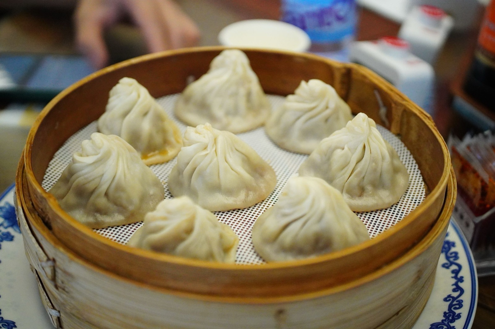 Xiaolongbao soup dumplings in a bamboo steamer.