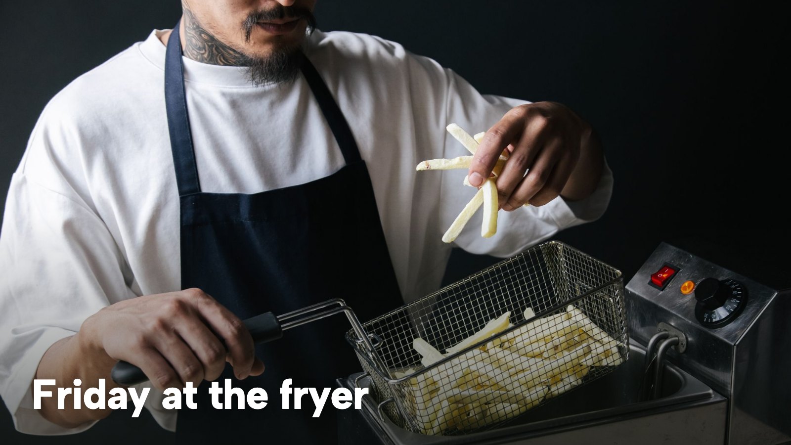 A cook in an apron lowering a basket of chips into a deep fryer. The image carries the words "Friday at the fryer".