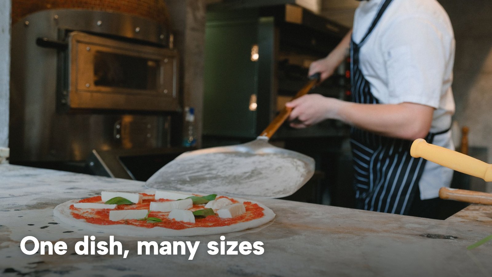A chef preparing a fresh pizza on a counter beside a pizzeria oven. The image carries the words "One dish, many sizes".
