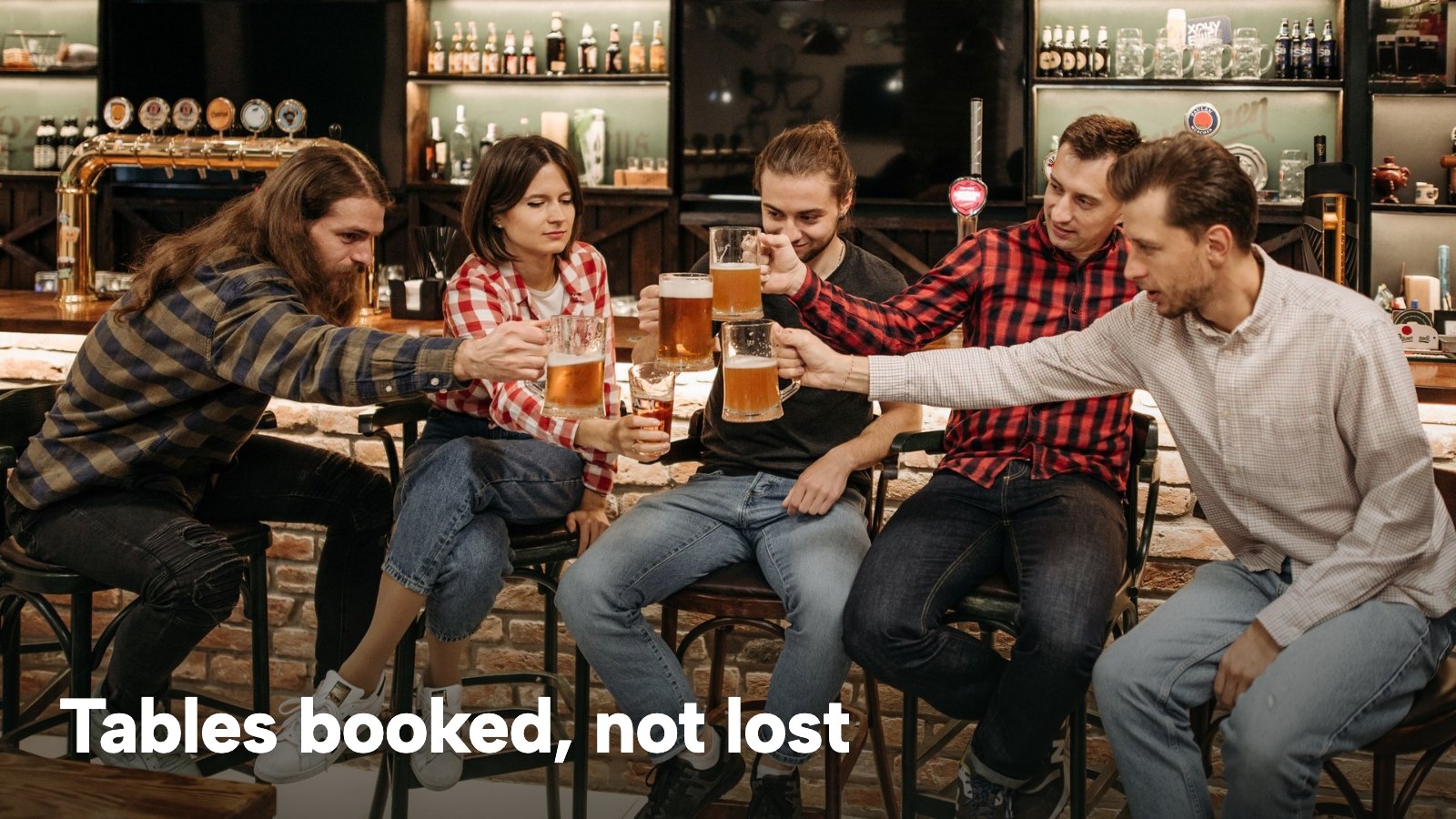 Five friends raising beer glasses together in a pub. The image carries the words "Tables booked, not lost".