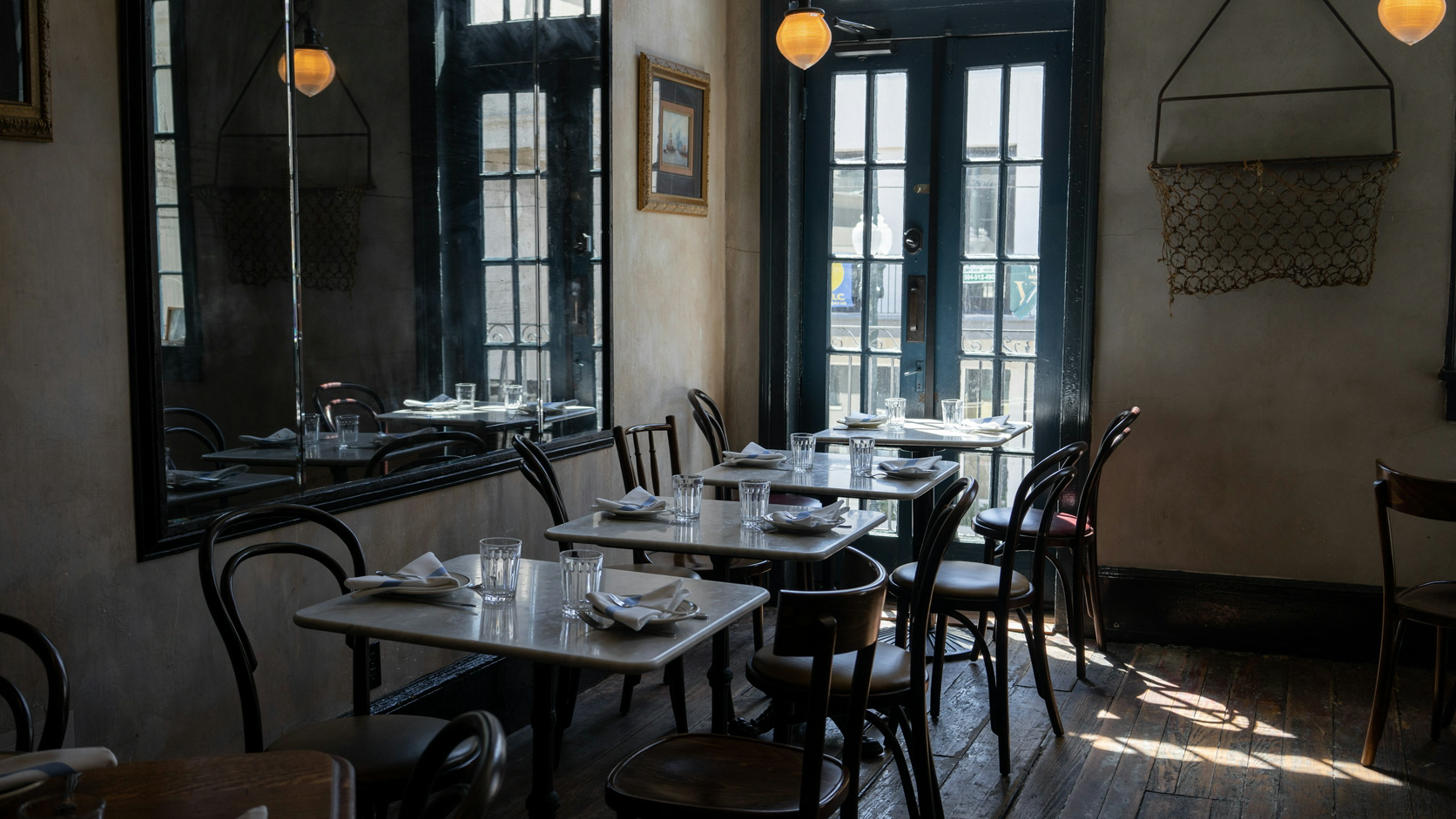 A restaurant dining room with a visible glazed entrance door.
