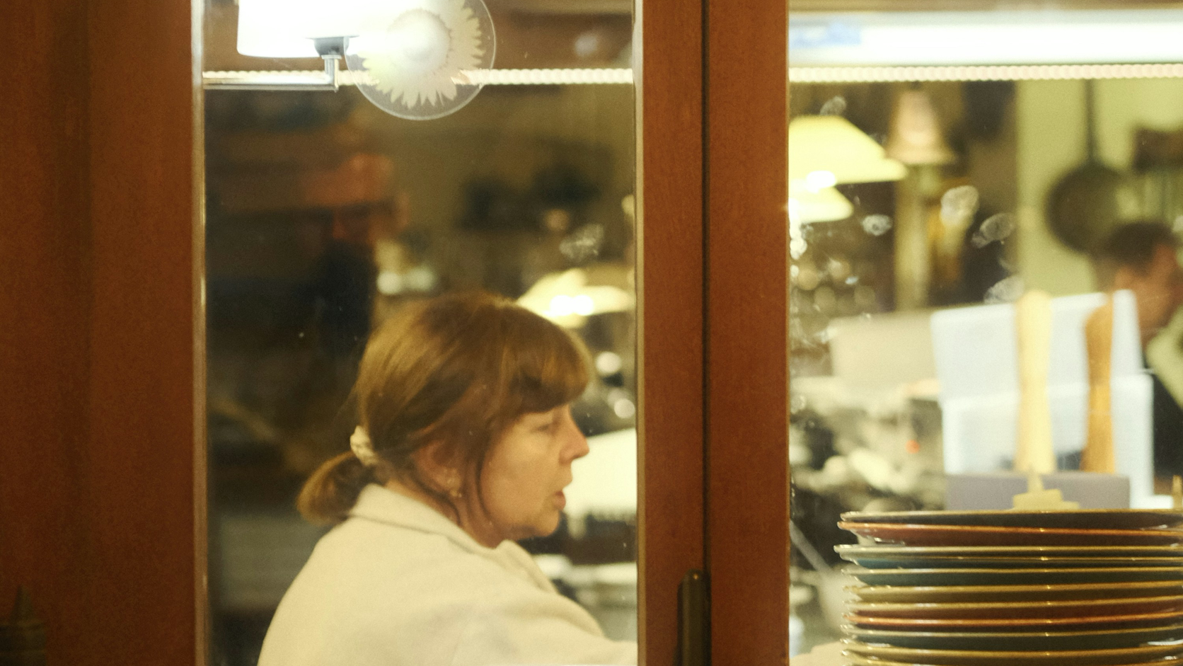 A restaurant team member working behind the kitchen pass.