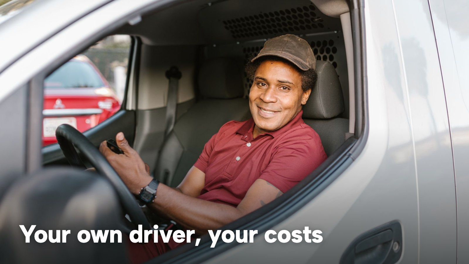 A smiling delivery driver in a red shirt sits at the wheel of a white van. The image carries the words "Your own driver, your costs".
