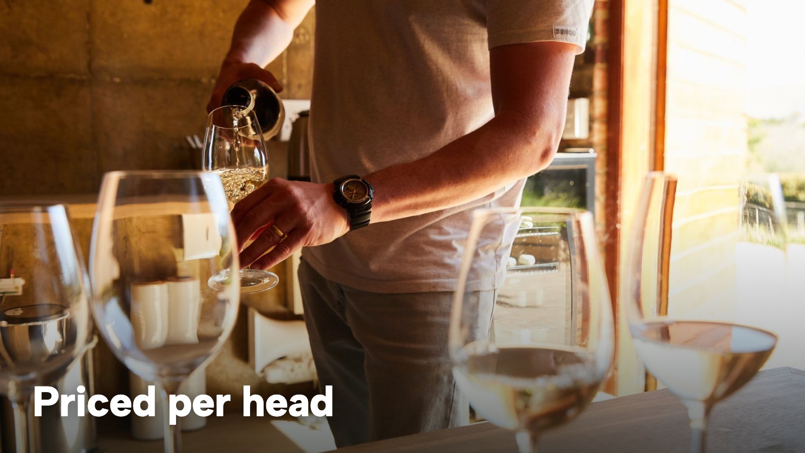 Wine being poured into glasses lined up for a tasting. The image carries the words "Priced per head".