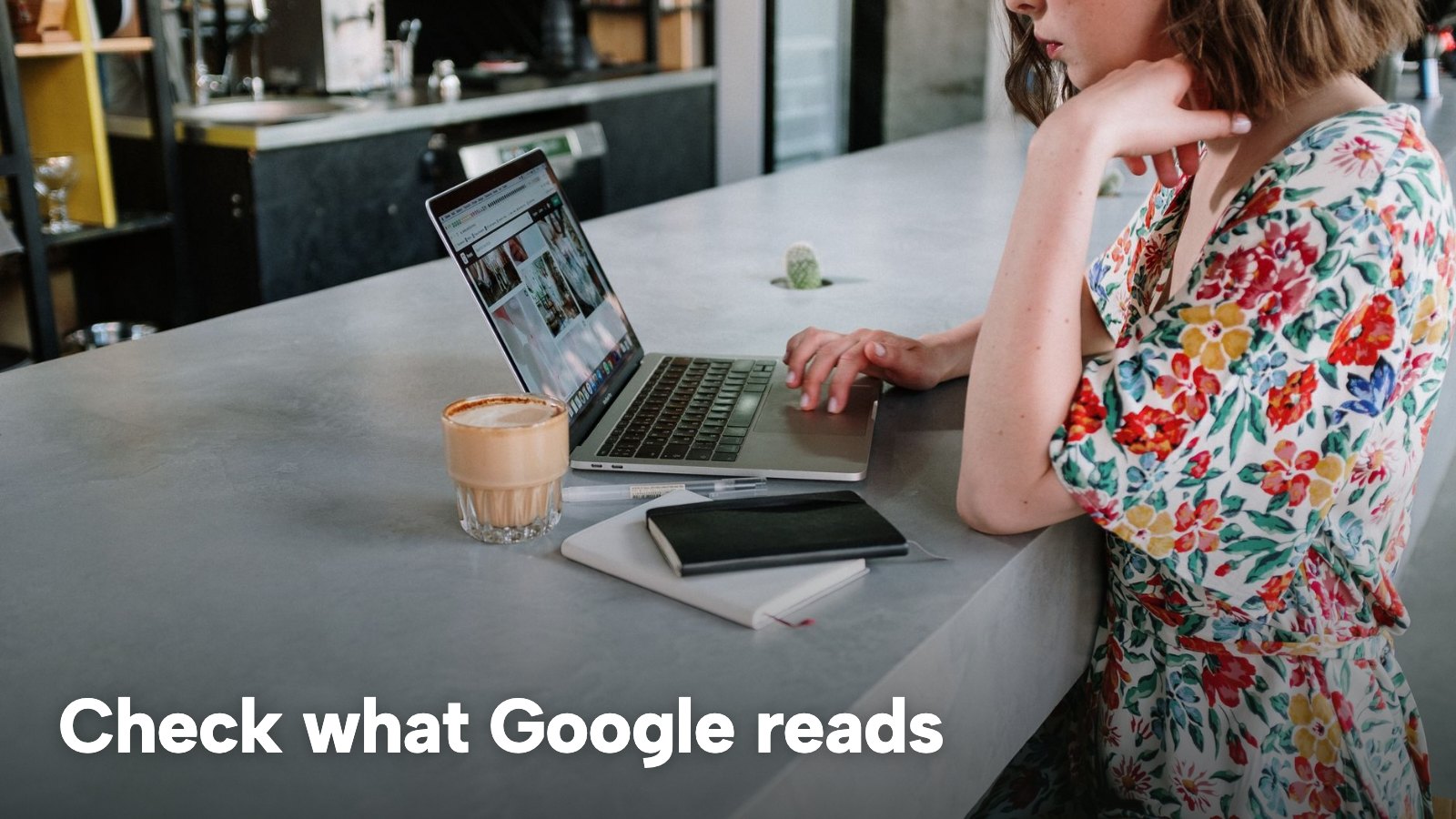 A woman at a café counter works on a laptop. The image carries the words "Check what Google reads".