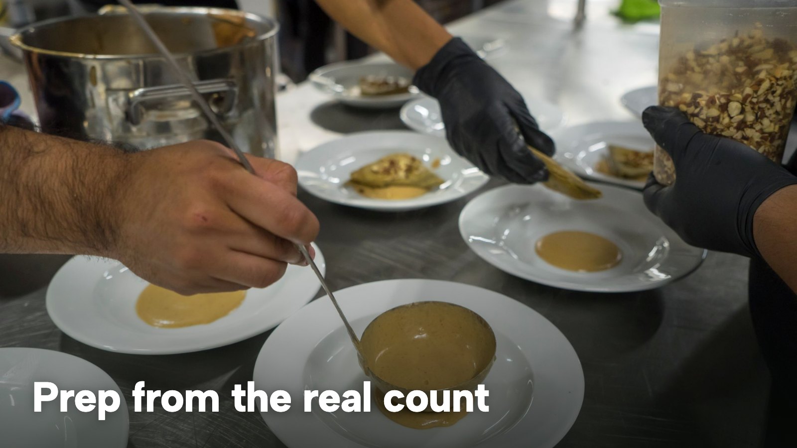 Chefs plating rows of identical bowls of soup on a steel counter. The image carries the words "Prep from the real count".