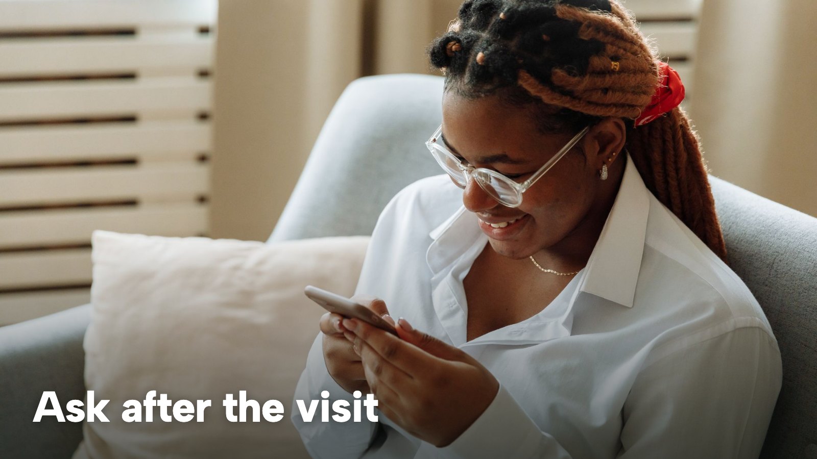 A woman in a white shirt smiling as she reads her phone. The image carries the words "Ask after the visit".