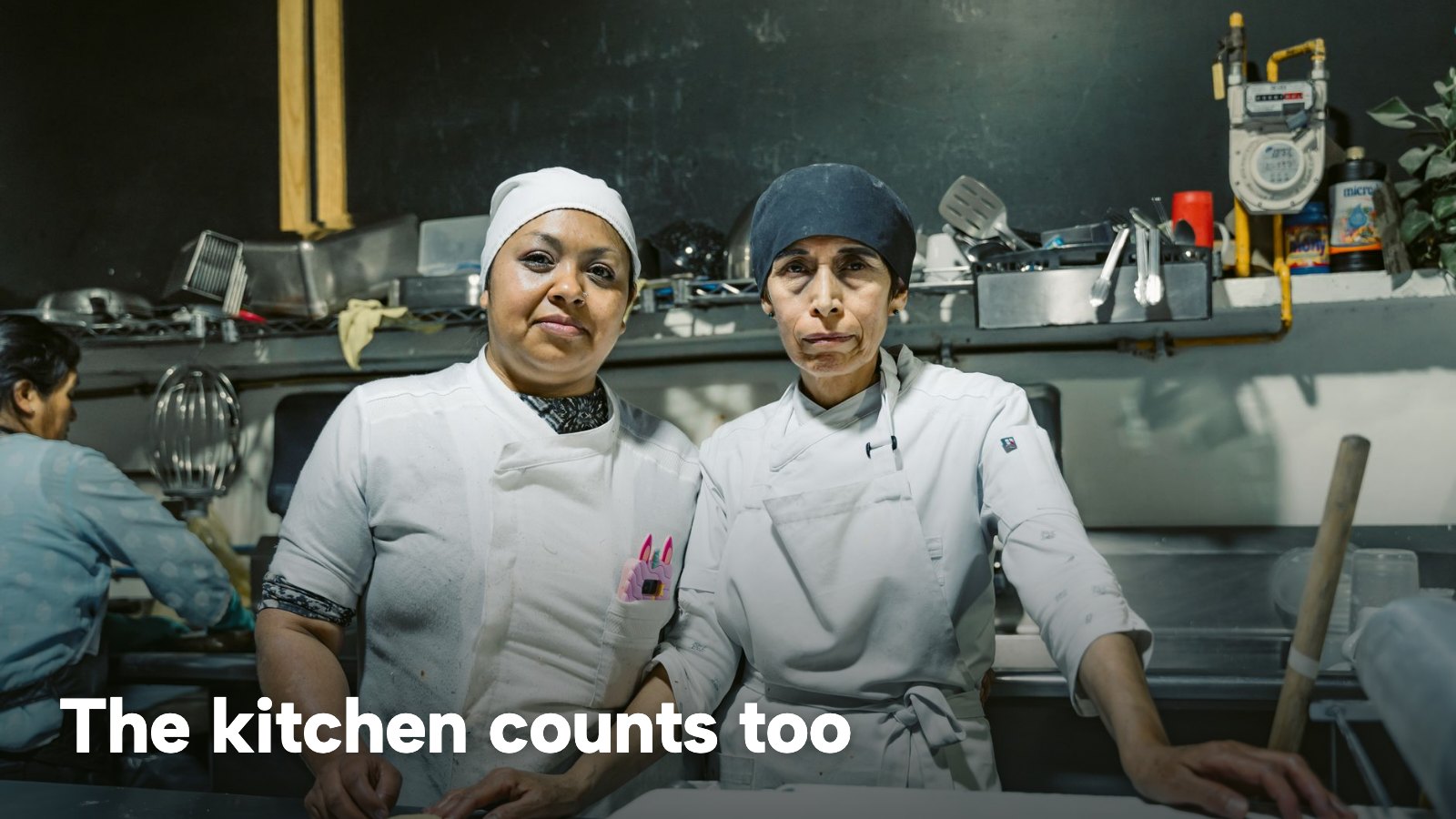 Two chefs in white jackets in a restaurant kitchen. The image carries the words "The kitchen counts too".